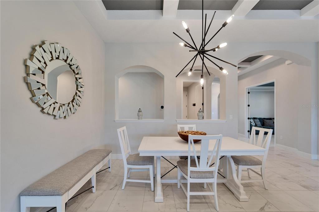 9152 Warm Spgs Circle Parrish, FL 34219 - Photo 11 of 38 a dining room with a table and chairs