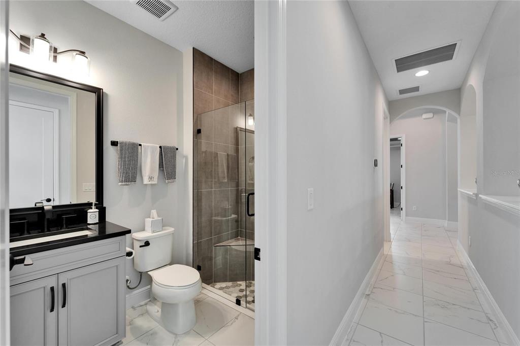 9152 Warm Spgs Circle Parrish, FL 34219 - Photo 18 of 38 a bathroom with a toilet a sink and a mirror