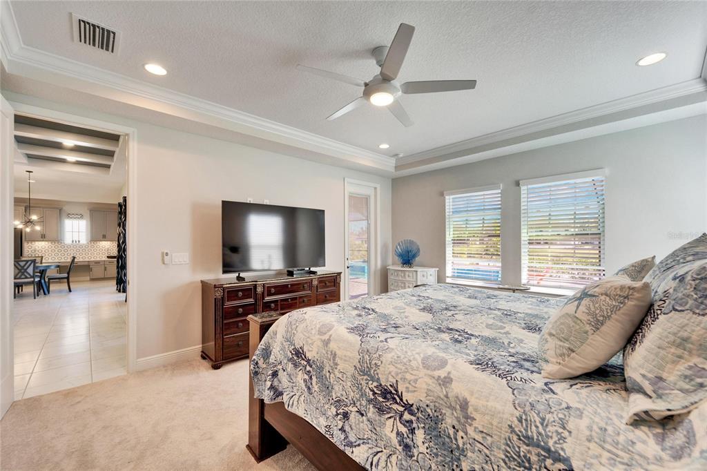 9152 Warm Spgs Circle Parrish, FL 34219 - Photo 21 of 38 a bedroom with a bed and a flat tv screen on the dresser