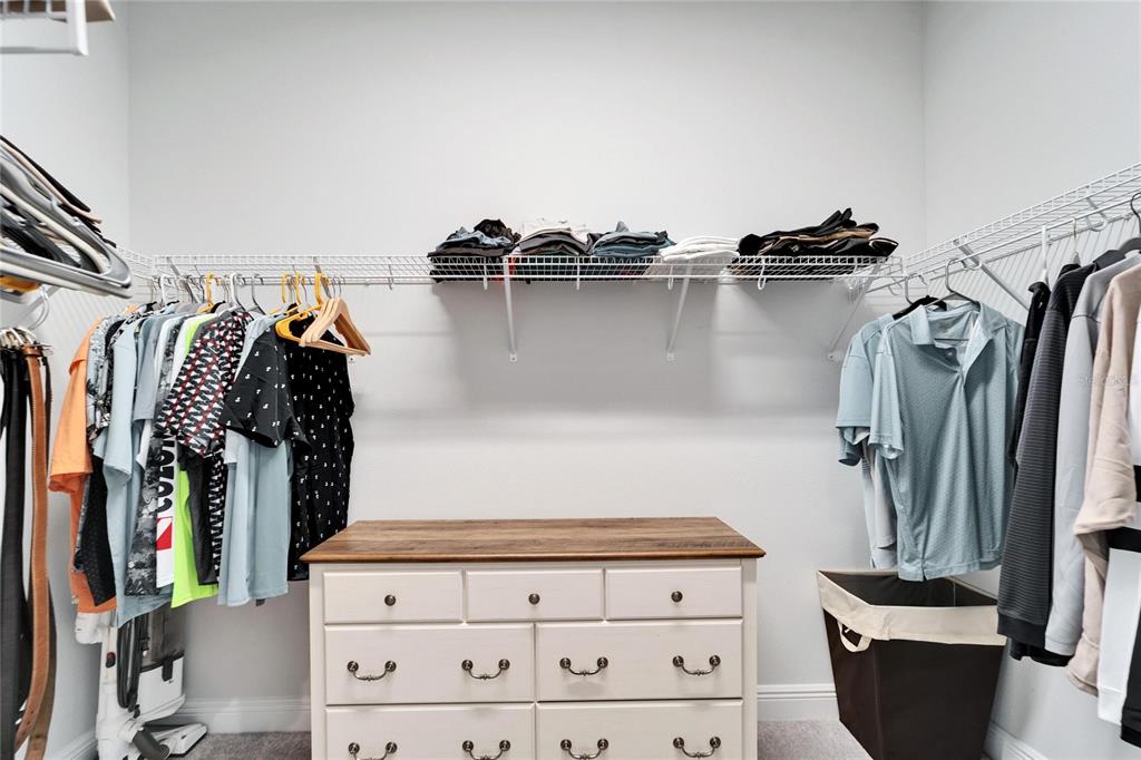 9152 Warm Spgs Circle Parrish, FL 34219 - Photo 22 of 38 a view of walk in closet with clothes and shoes