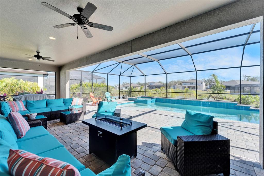 9152 Warm Spgs Circle Parrish, FL 34219 - Photo 26 of 38 a living room with patio furniture and a fireplace