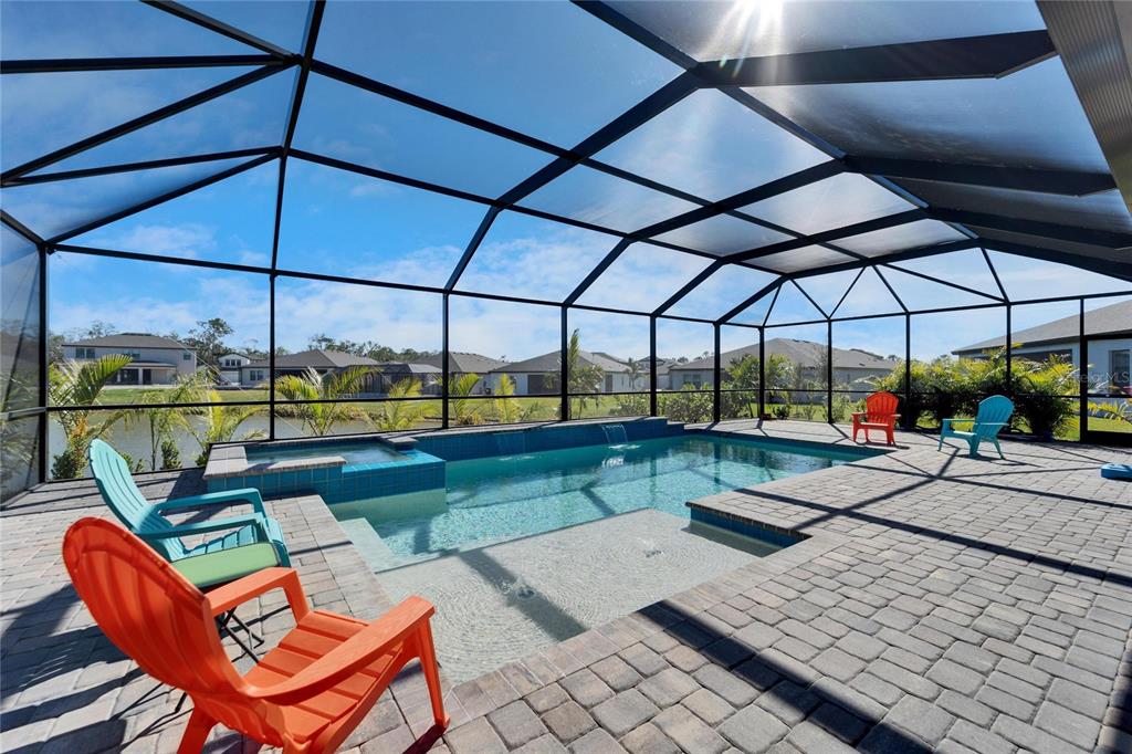 9152 Warm Spgs Circle Parrish, FL 34219 - Photo 27 of 38 a view of a patio with a table and chairs under an umbrella