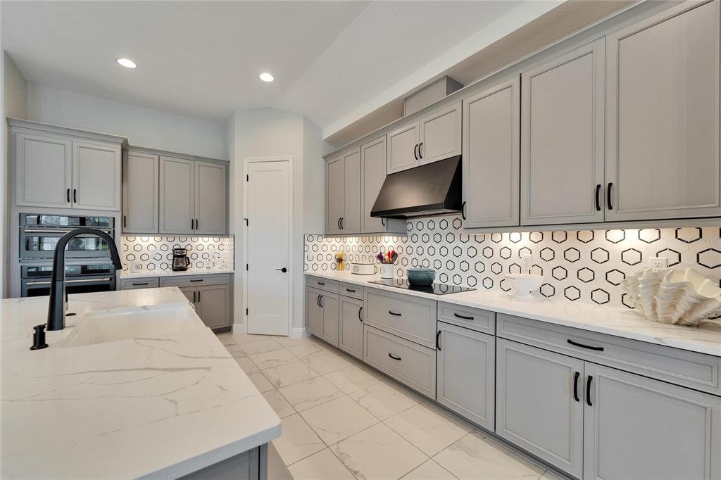 9152 Warm Spgs Circle Parrish, FL 34219 - Photo 9 of 38 a kitchen with granite countertop white cabinets and stainless steel appliances