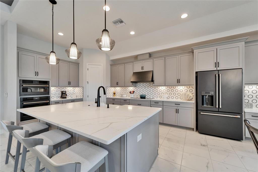 9152 Warm Spgs Circle Parrish, FL 34219 - Photo 10 of 38 a kitchen with cabinets and stainless steel appliances