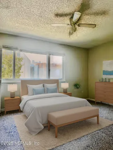 a bedroom with a bed a couch and a large window