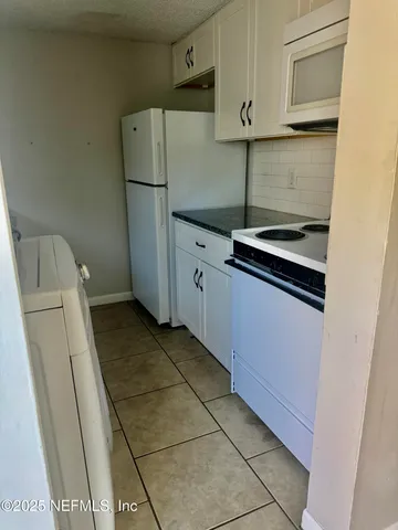 a kitchen with appliances and cabinets