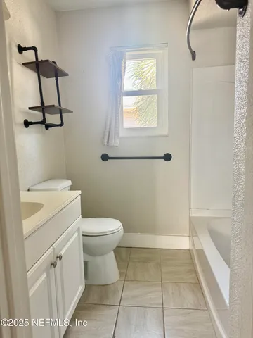 a bathroom with a toilet sink and vanity