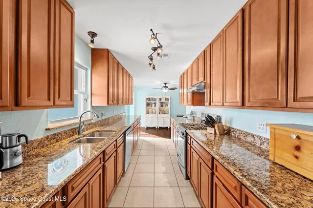 a kitchen with stainless steel appliances granite countertop a sink stove and cabinets