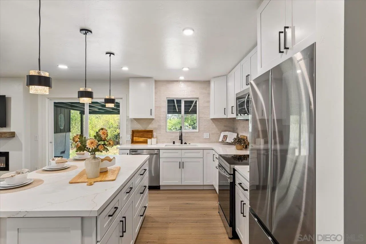 30118 Miller Road Valley Center, CA 92082 - Photo 13 of 75 a kitchen with kitchen island a sink stove and refrigerator
