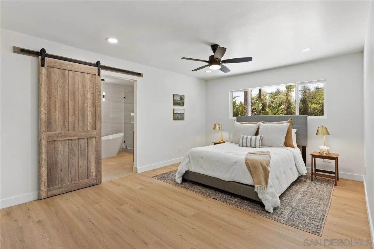 30118 Miller Road Valley Center, CA 92082 - Photo 20 of 75 a spacious bedroom with a bed and a flat screen tv