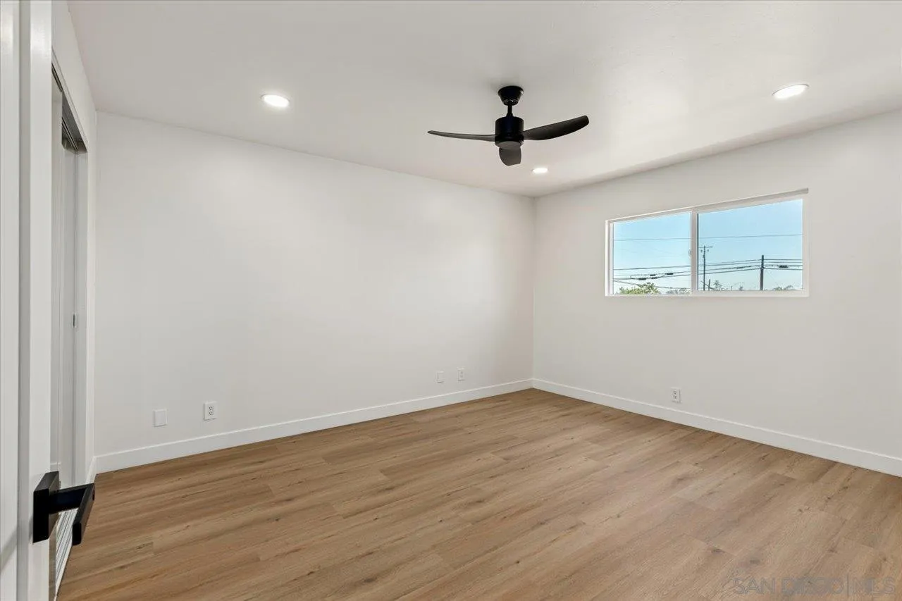 30118 Miller Road Valley Center, CA 92082 - Photo 31 of 75 an empty room with wooden floor fan and windows