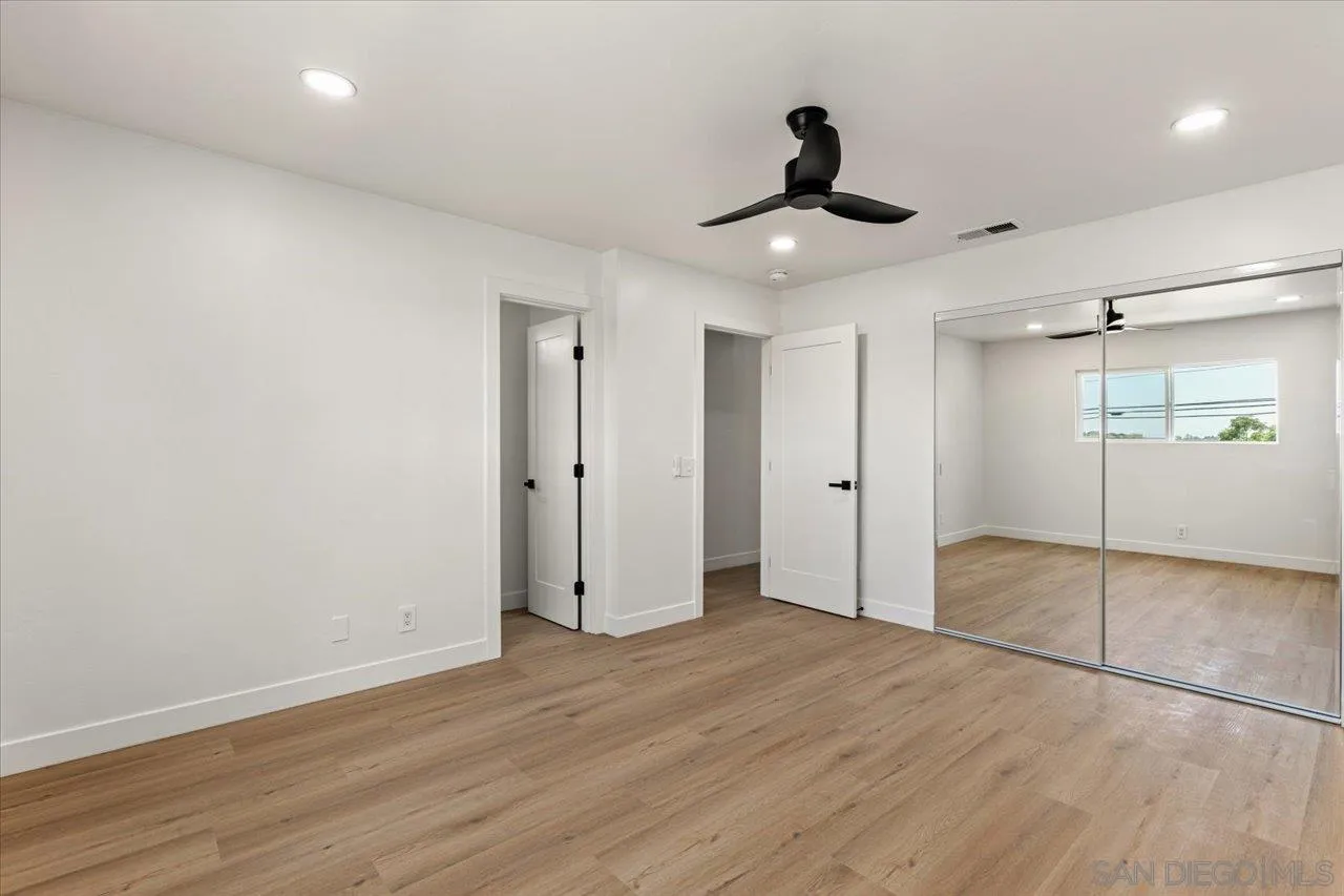30118 Miller Road Valley Center, CA 92082 - Photo 32 of 75 a view of an empty room with wooden floor and a ceiling fan