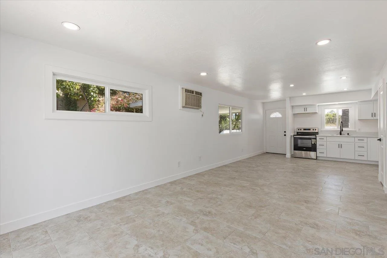 30118 Miller Road Valley Center, CA 92082 - Photo 42 of 75 an empty room with furniture and view of kitchen