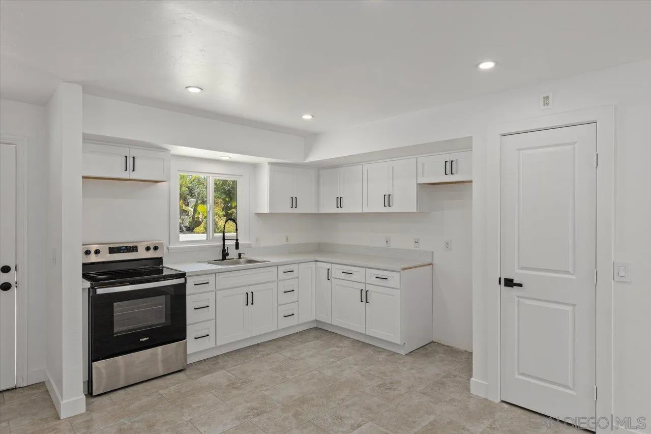 30118 Miller Road Valley Center, CA 92082 - Photo 43 of 75 a kitchen with white cabinets and stainless steel appliances