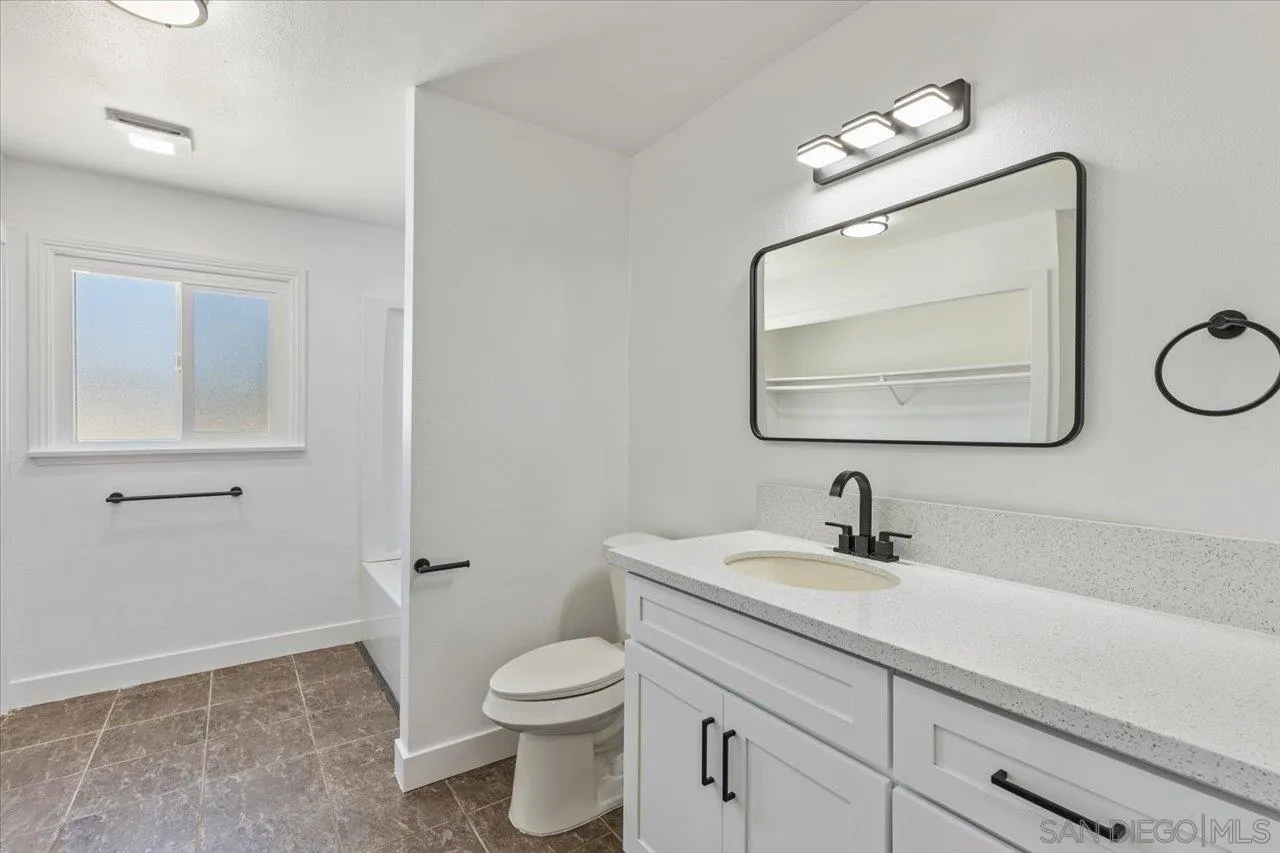 30118 Miller Road Valley Center, CA 92082 - Photo 46 of 75 a bathroom with a toilet sink and mirror