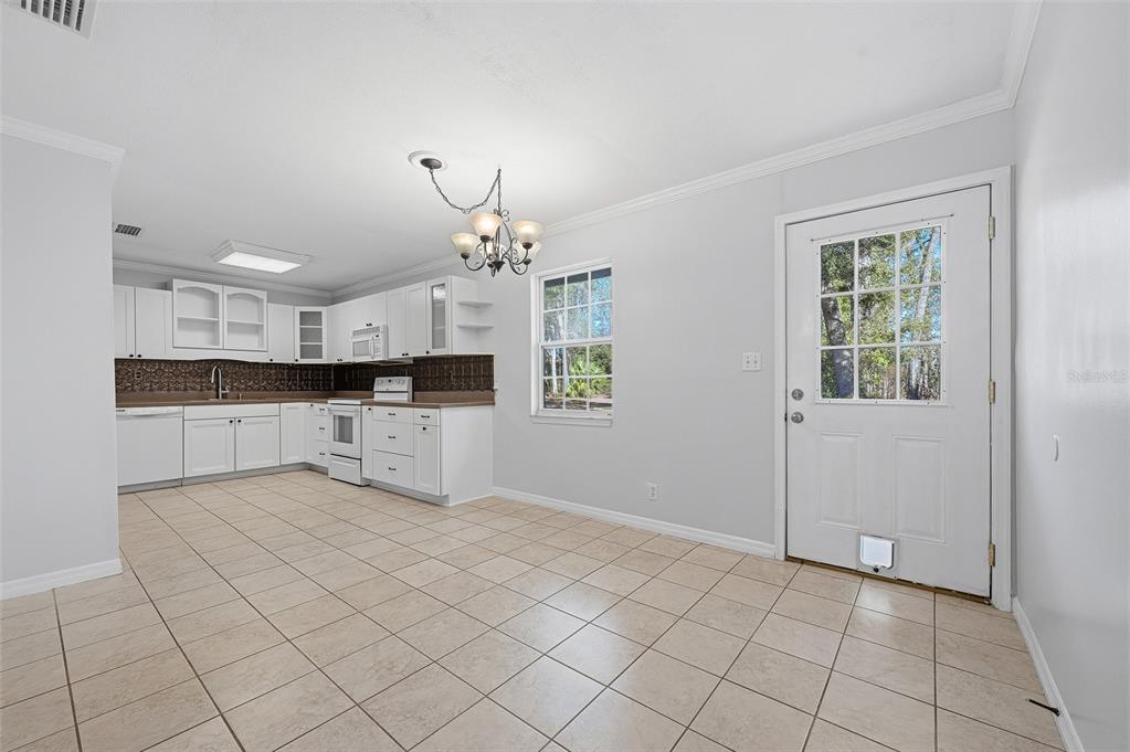 6878 Southwest 36th Street Lake Butler, FL 32054 - Photo 12 of 30 an empty room with kitchen view and windows