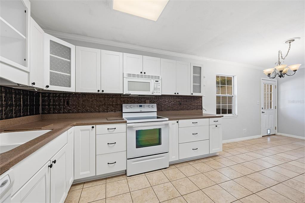 6878 Southwest 36th Street Lake Butler, FL 32054 - Photo 14 of 30 a kitchen with white cabinets and white appliances