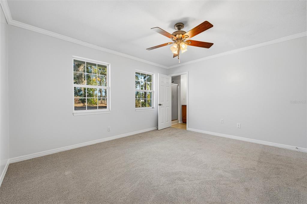 6878 Southwest 36th Street Lake Butler, FL 32054 - Photo 18 of 30 an empty room with window and ceiling fan