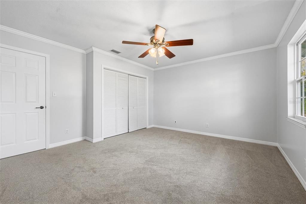 6878 Southwest 36th Street Lake Butler, FL 32054 - Photo 21 of 30 an empty room with windows and fan