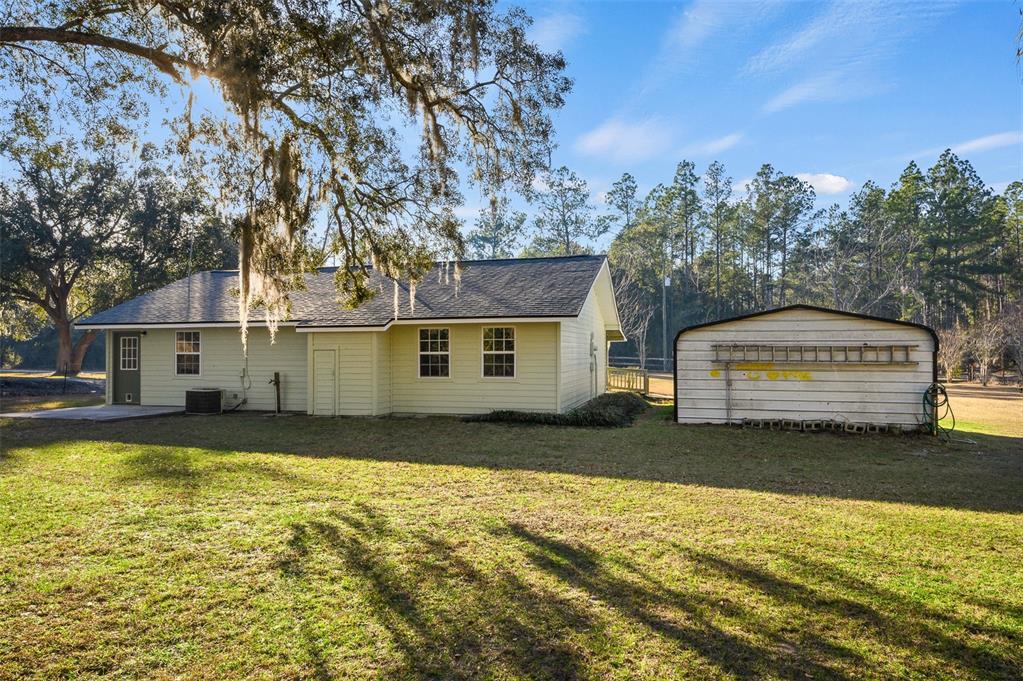 6878 Southwest 36th Street Lake Butler, FL 32054 - Photo 25 of 30 a front view of a house with a yard