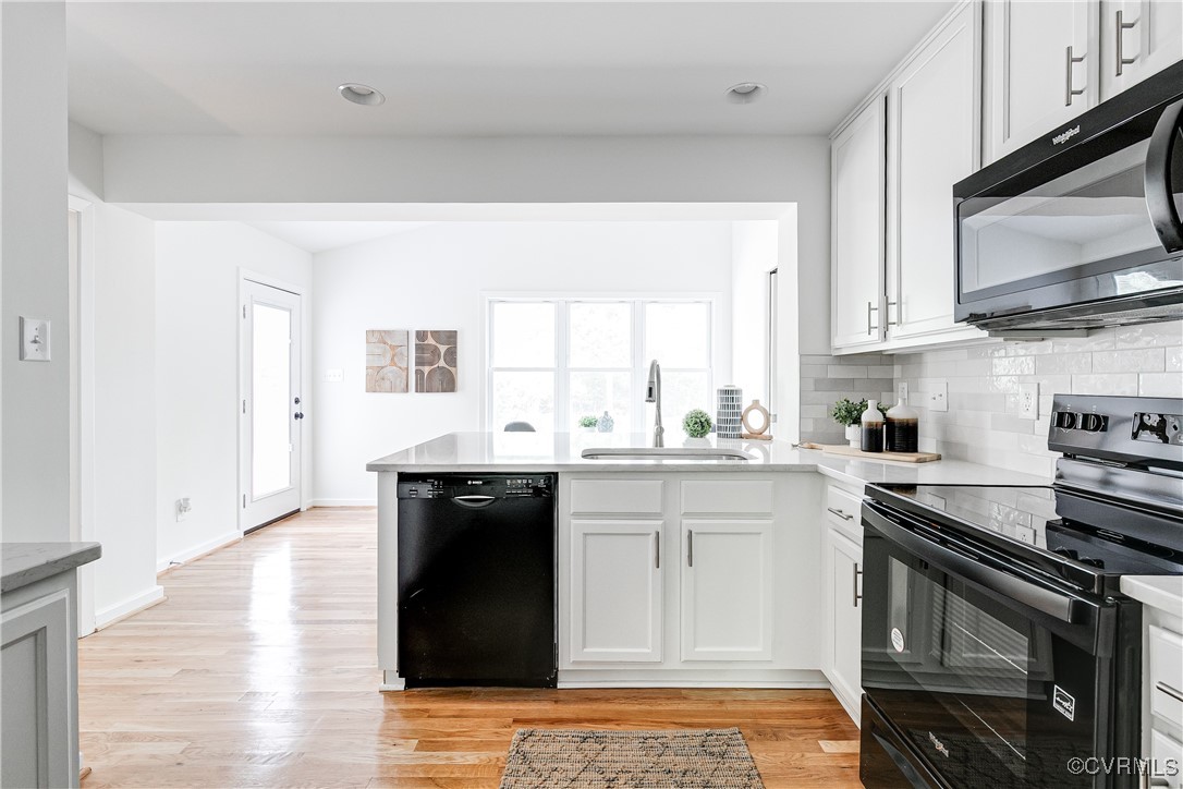 7654 Cherokee Road Richmond, VA 23225 - Photo 11 of 35 a kitchen with stainless steel appliances granite countertop a stove a sink and a microwave
