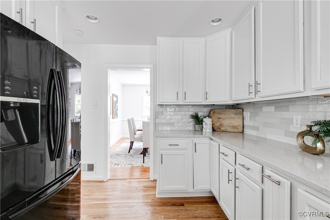 7654 Cherokee Road Richmond, VA 23225 - Photo 12 of 35 a kitchen with white cabinets and refrigerator