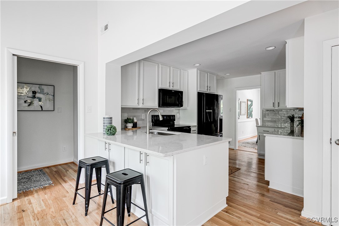 7654 Cherokee Road Richmond, VA 23225 - Photo 14 of 35 a kitchen with white cabinets and stainless steel appliances