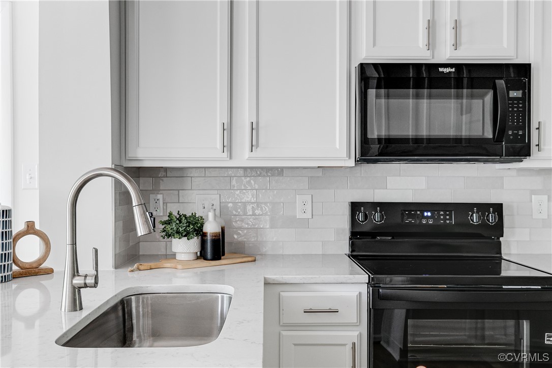 7654 Cherokee Road Richmond, VA 23225 - Photo 16 of 35 a kitchen with a sink stove and microwave