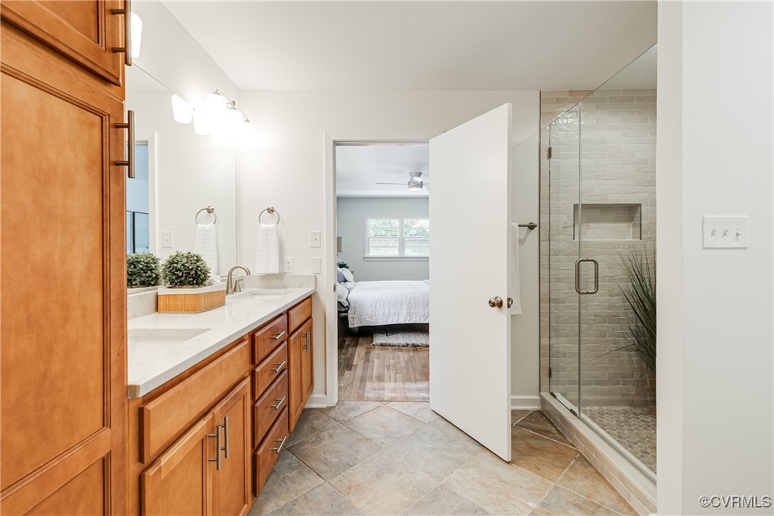 7654 Cherokee Road Richmond, VA 23225 - Photo 21 of 35 a bathroom with a double vanity sink and mirror