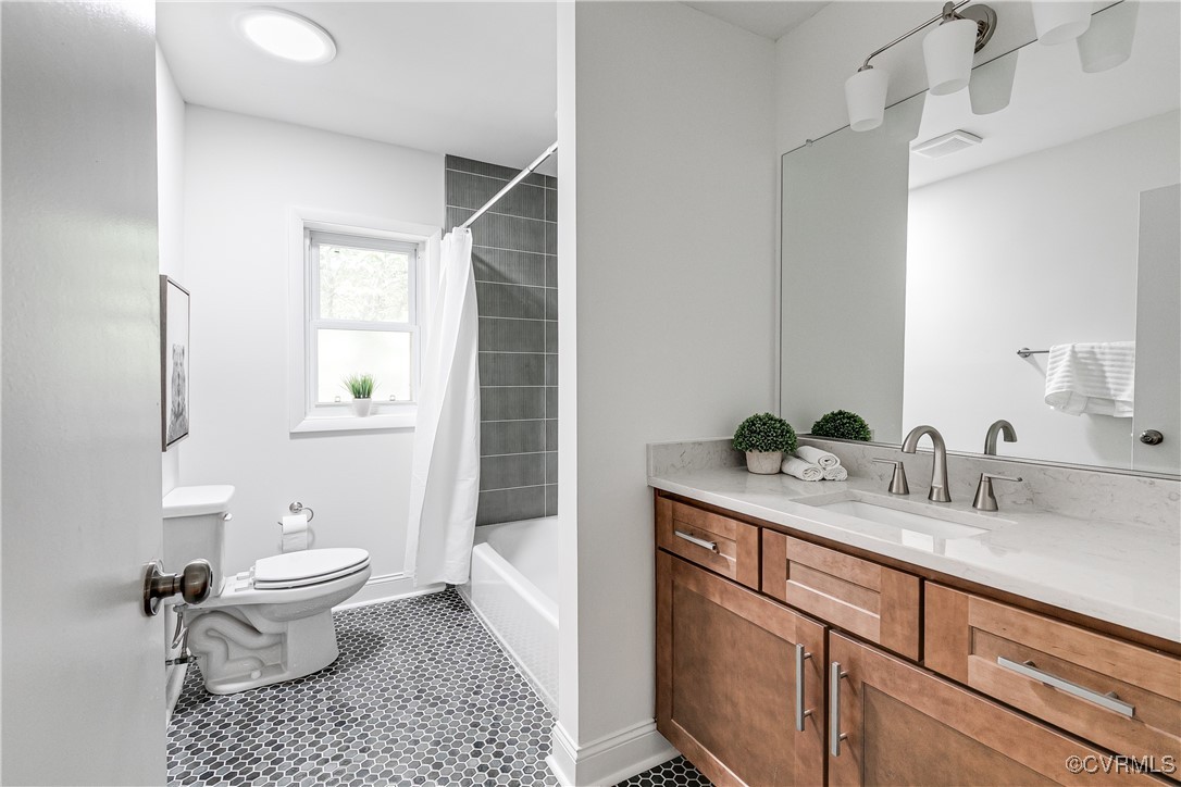 7654 Cherokee Road Richmond, VA 23225 - Photo 29 of 35 a bathroom with a granite countertop sink a toilet and a mirror