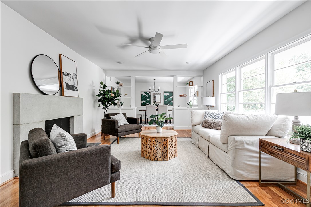 7654 Cherokee Road Richmond, VA 23225 - Photo 3 of 35 a living room with furniture a fireplace and a large window