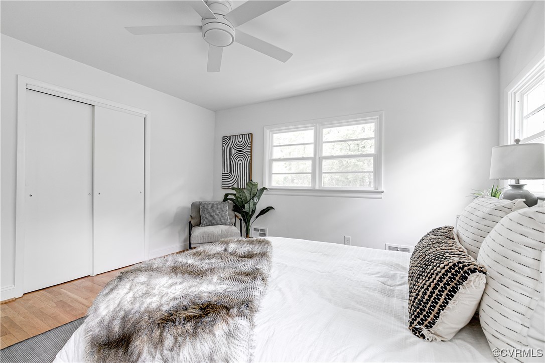 7654 Cherokee Road Richmond, VA 23225 - Photo 32 of 35 a bedroom with a bed and a chandelier