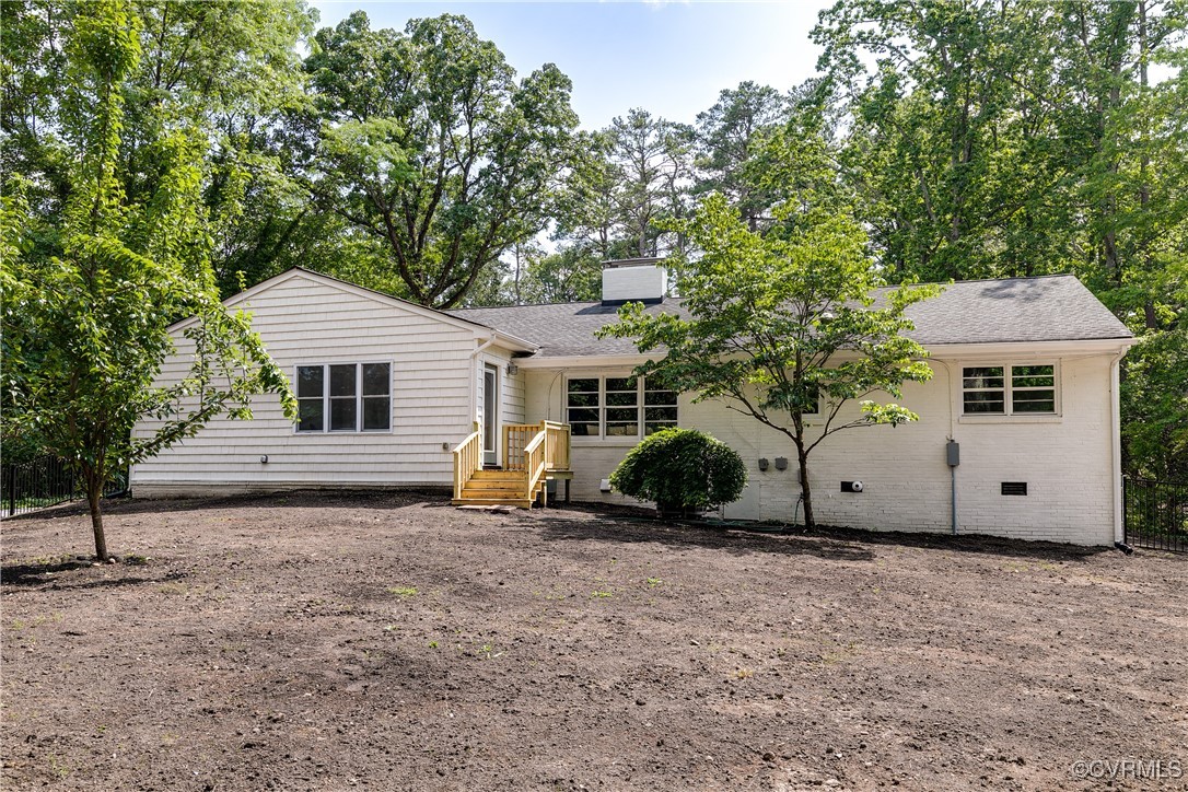 7654 Cherokee Road Richmond, VA 23225 - Photo 34 of 35 a view of a white house with a large tree and a yard