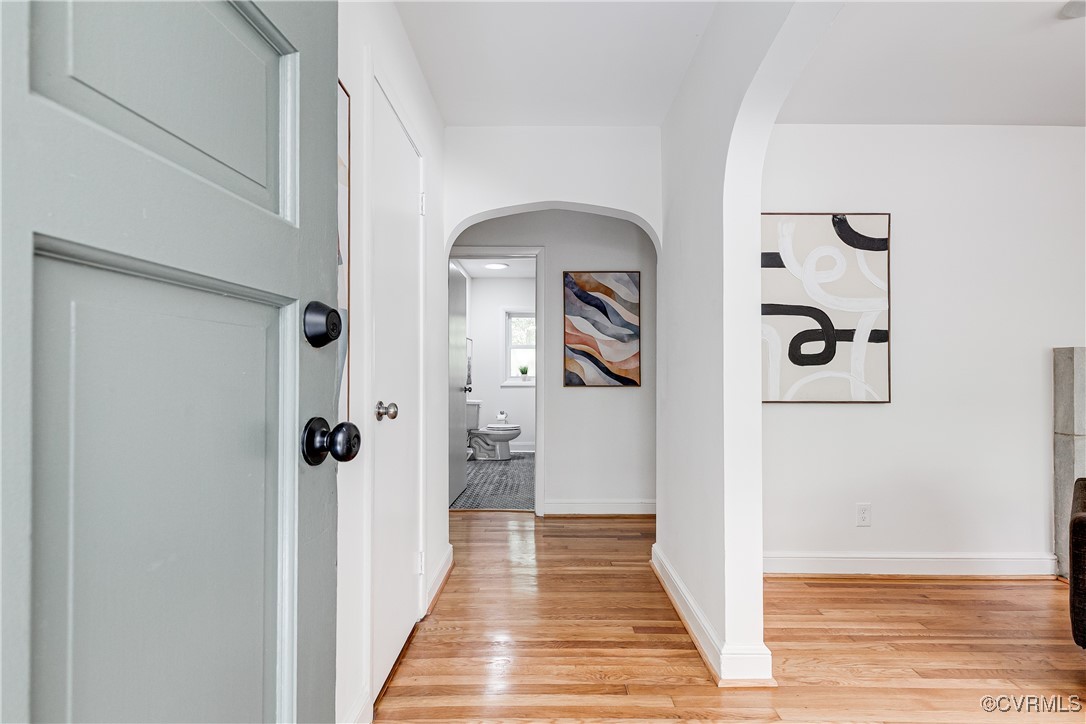 7654 Cherokee Road Richmond, VA 23225 - Photo 4 of 35 a view of a hallway with wooden floor and a bathroom