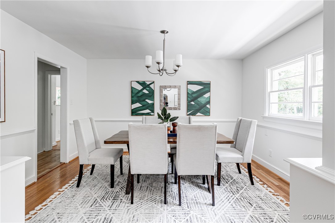 7654 Cherokee Road Richmond, VA 23225 - Photo 9 of 35 a view of a dining room with furniture a chandelier and wooden floor