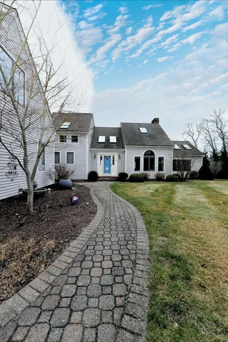 a front view of a house with a garden