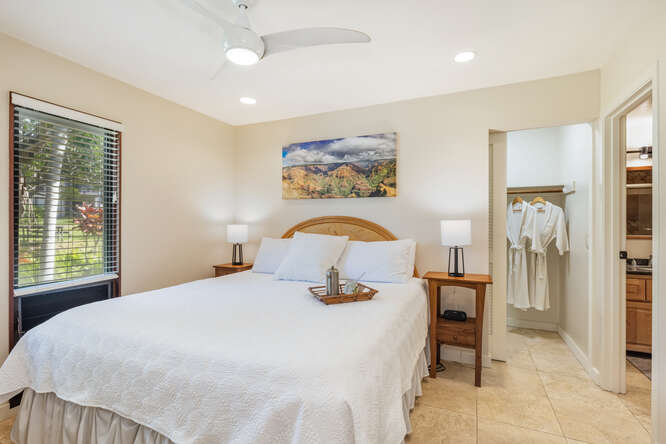 1901 Poipu Road, Unit 311 Koloa, HI 96756 - Photo 12 of 29 a bedroom with a bed and a painting on the wall