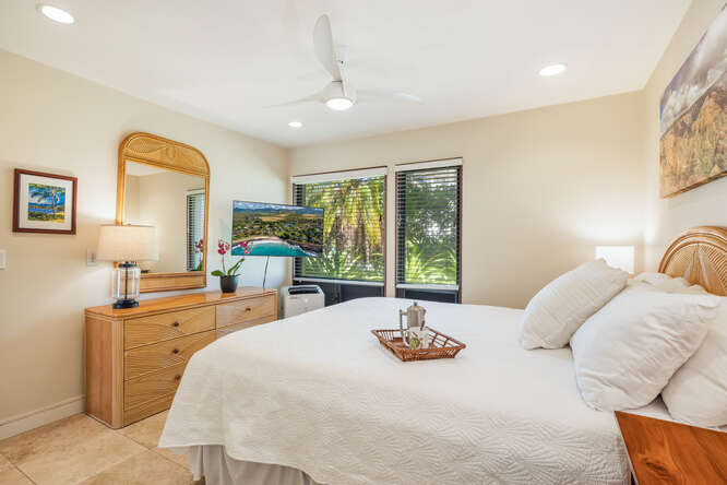 1901 Poipu Road, Unit 311 Koloa, HI 96756 - Photo 13 of 29 a bedroom with a large bed and a table