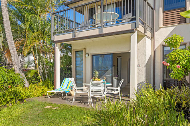 1901 Poipu Road, Unit 311 Koloa, HI 96756 - Photo 21 of 29 a view of a patio with table and chairs and potted plants with wooden fence