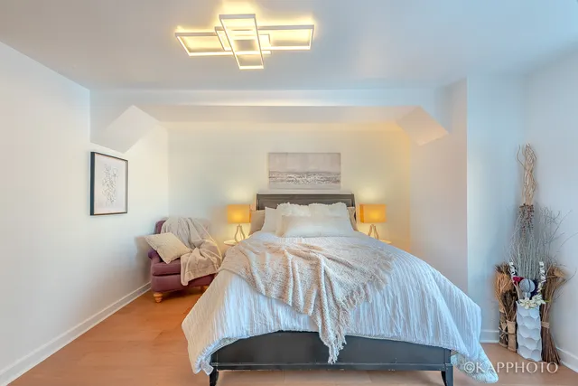 a bedroom with a bed and a chandelier