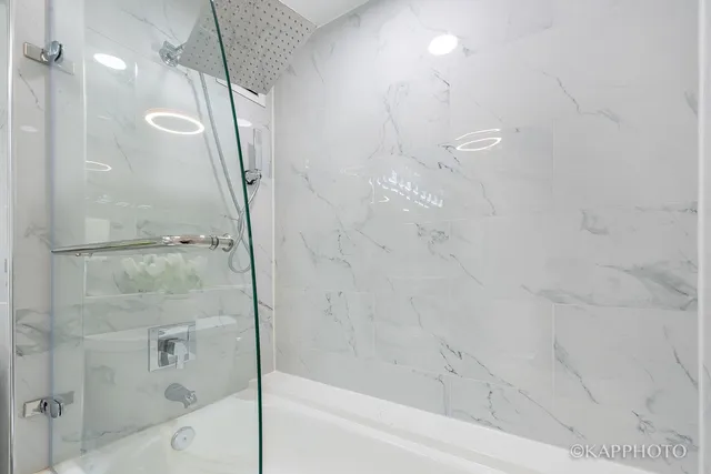 a bathroom with a bathtub and a shower