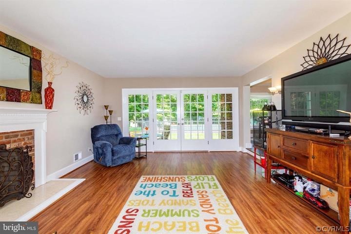 2400 Butler Road Beaverdam, VA 23015 - Photo 11 of 46 a living room with furniture a flat screen tv and a fireplace