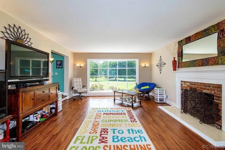 2400 Butler Road Beaverdam, VA 23015 - Photo 12 of 46 a living room with furniture a flat screen tv and a fireplace