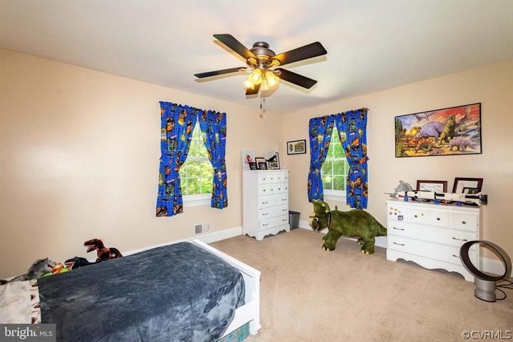 2400 Butler Road Beaverdam, VA 23015 - Photo 32 of 46 a bedroom with a bed and a chandelier