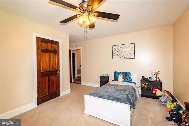 2400 Butler Road Beaverdam, VA 23015 - Photo 33 of 46 a bedroom with a bed and a chandelier