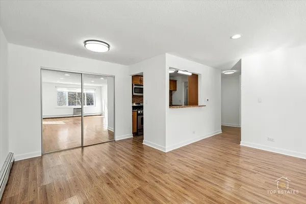 a view of a kitchen counter space and wooden floor