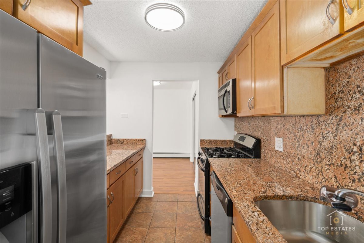 1107 South Old Wilke Road, Unit 208 Rolling Meadows, IL 60005 - Photo 21 of 43 a kitchen with stainless steel appliances granite countertop a sink a stove and refrigerator