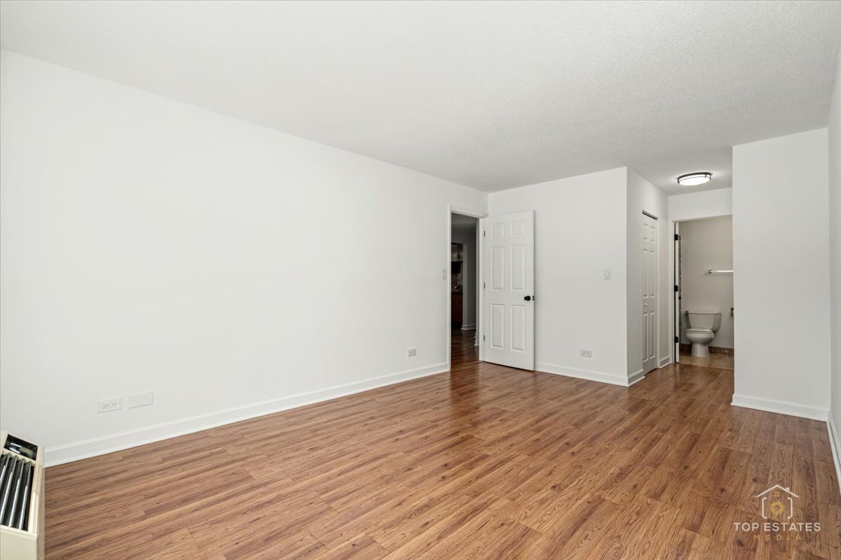 1107 South Old Wilke Road, Unit 208 Rolling Meadows, IL 60005 - Photo 25 of 43 a view of an empty room with wooden floor