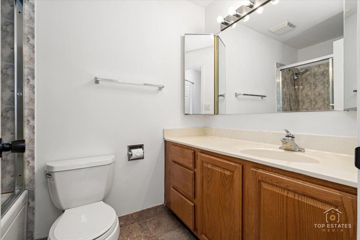 1107 South Old Wilke Road, Unit 208 Rolling Meadows, IL 60005 - Photo 27 of 43 a bathroom with a granite countertop toilet sink and mirror
