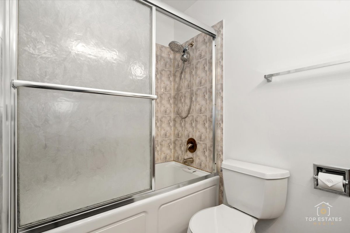 1107 South Old Wilke Road, Unit 208 Rolling Meadows, IL 60005 - Photo 28 of 43 a bathroom with a toilet and a shower